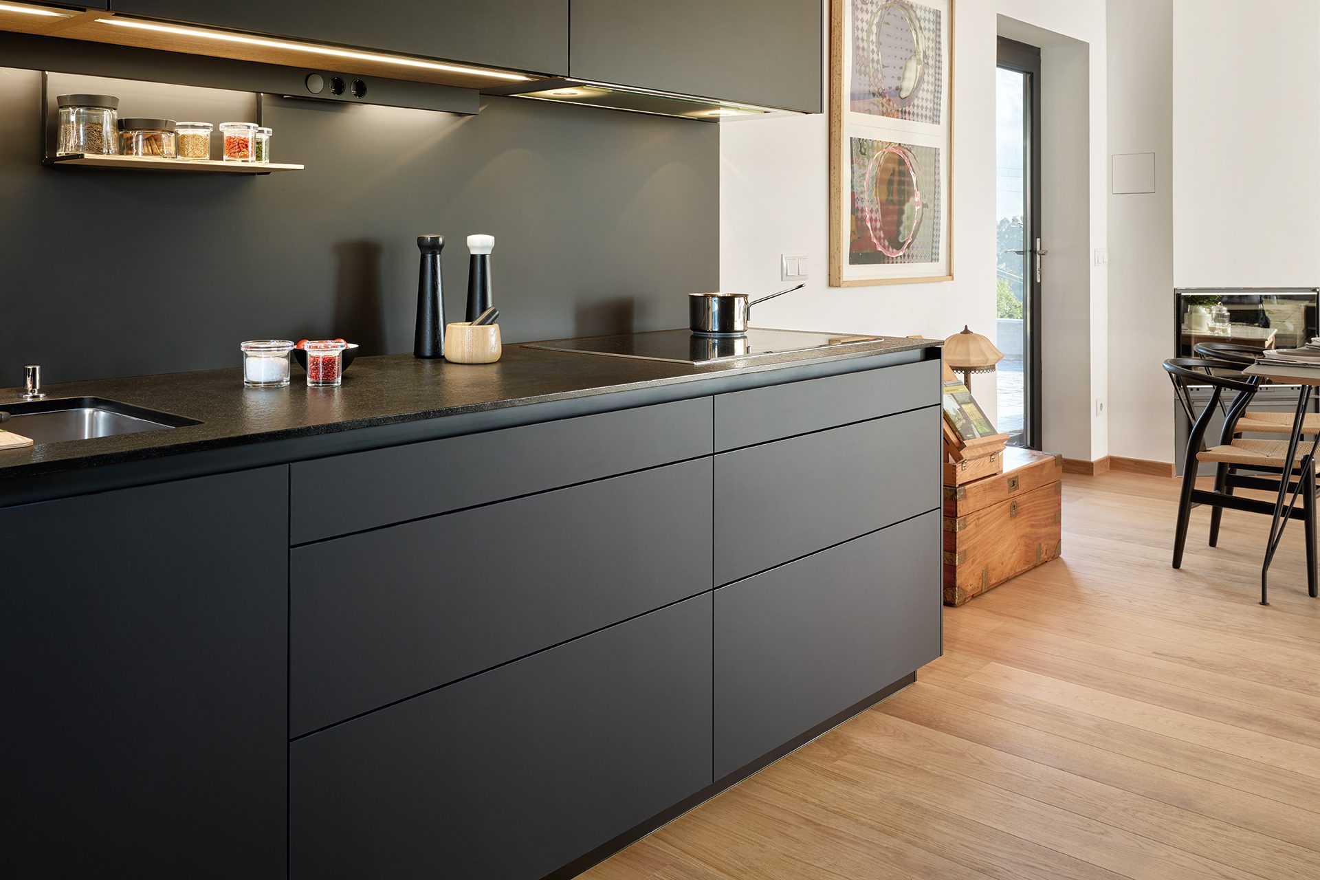 Black, parallel kitchen with a pull-out module system