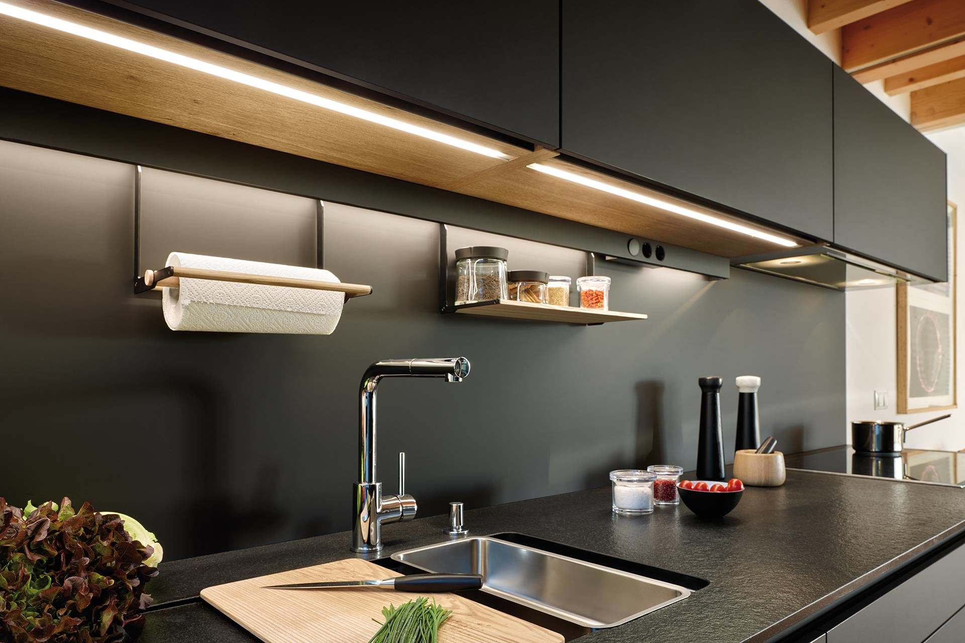 Image of LED lighting profile integrated in the lower part of a kitchen tall unit