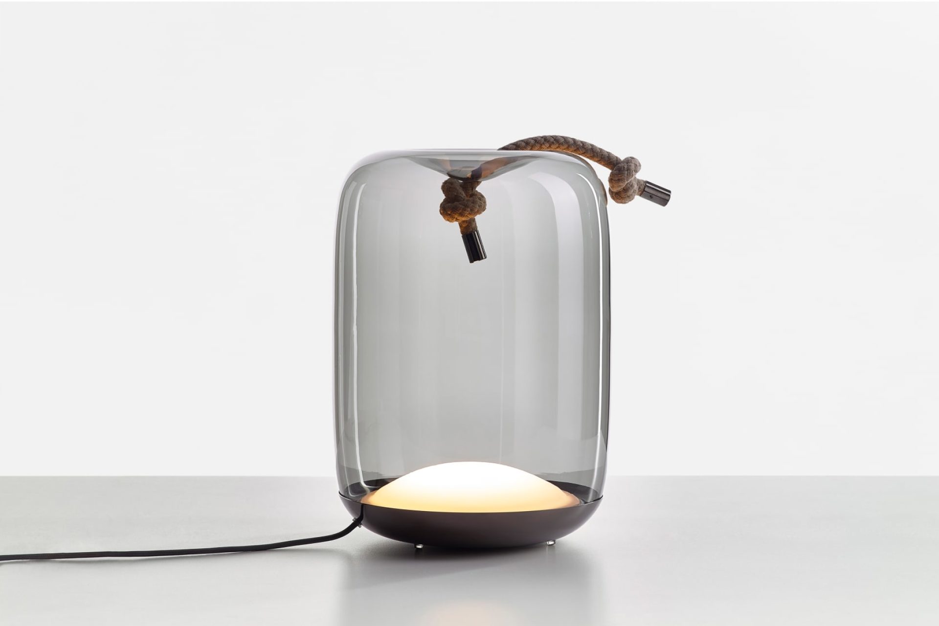 Table lamp made of glass with a decorative piece of rope