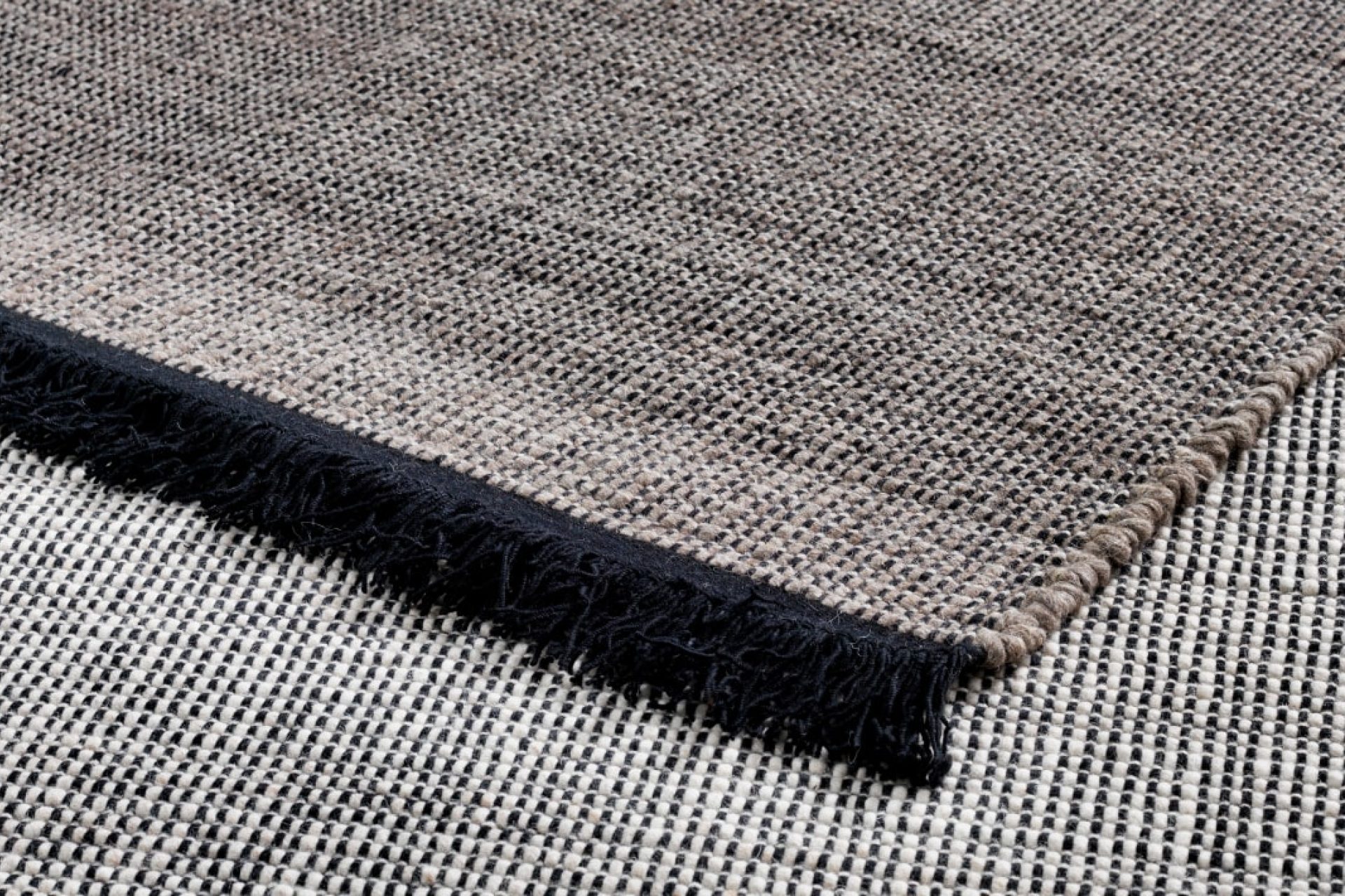 Display showing two parts of high-end, high-quality rugs