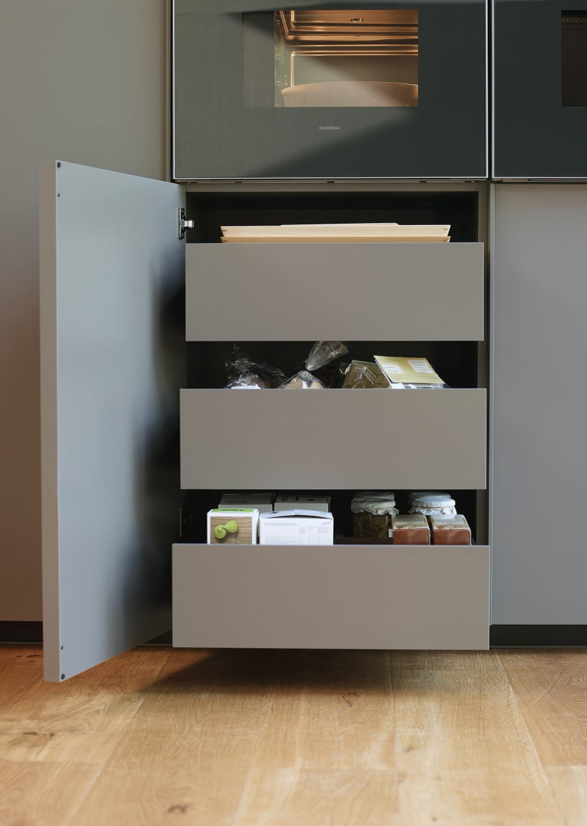 Grey kitchen cabinet with full-extension double drawers in tall units