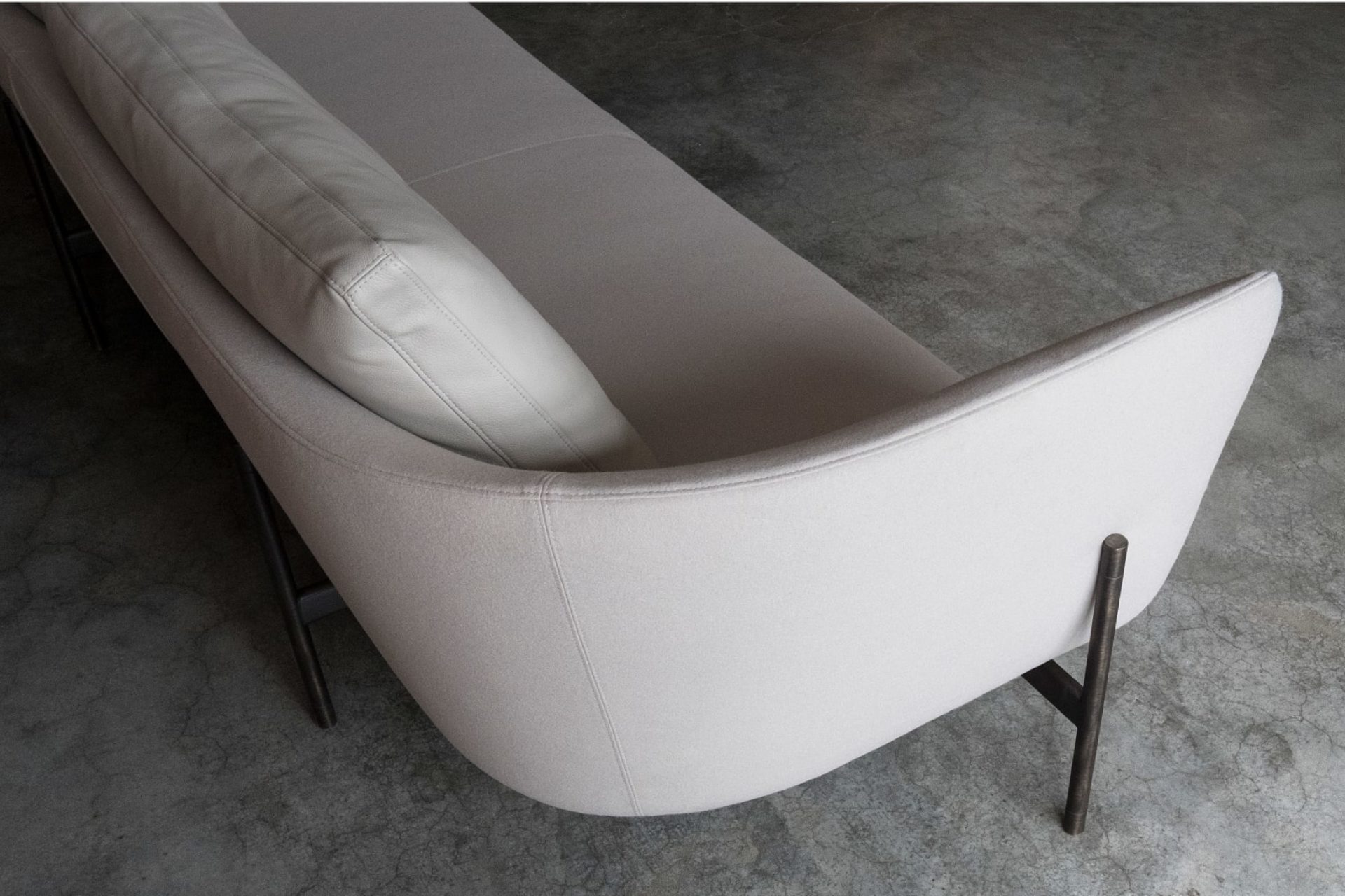 Picture depicting a beige canvas sofa with steel legs from above