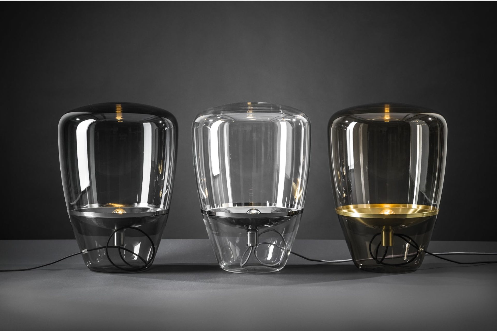 Three glass lamps, combining clear and smoked finishes and shaped like a hot air balloon
