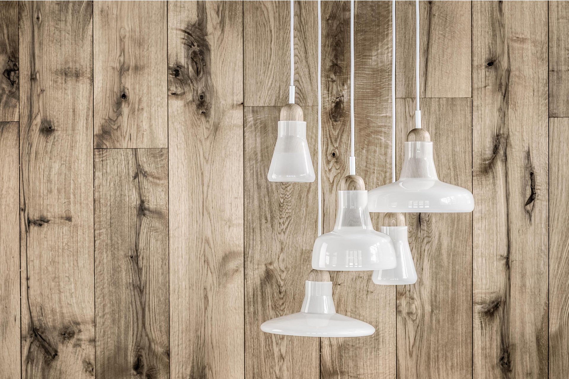 Luminaire comprised of five white glass pendant lamps
