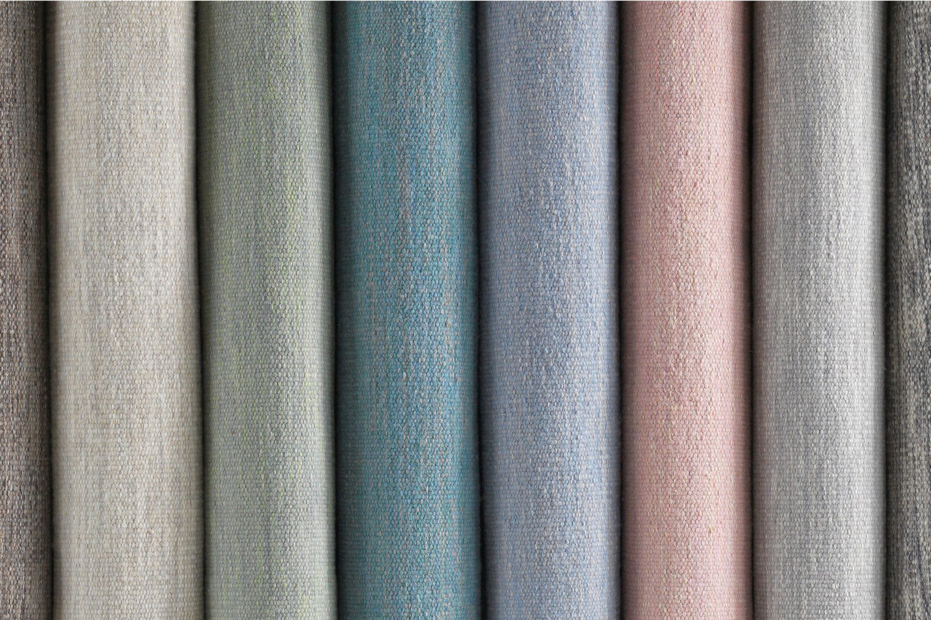 Rug fabric samples in various colours and tones